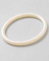 Macro detail of the polished pearlescent ivory Arden Slim Resin Bangle