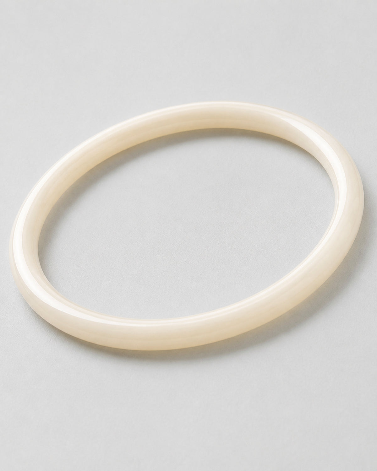 Macro detail of the polished pearlescent ivory Arden Slim Resin Bangle
