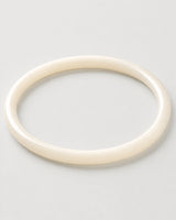 Alternate flat-lay view of the seamless Arden slim ivory bangle