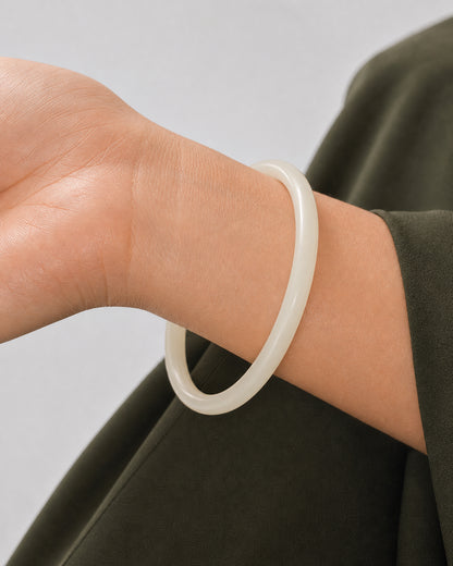 True worn macro of the complete ivory Arden Slim Resin Bangle around the wrist