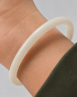 Extreme worn macro showing the pearlescent ivory construction of the Arden bangle