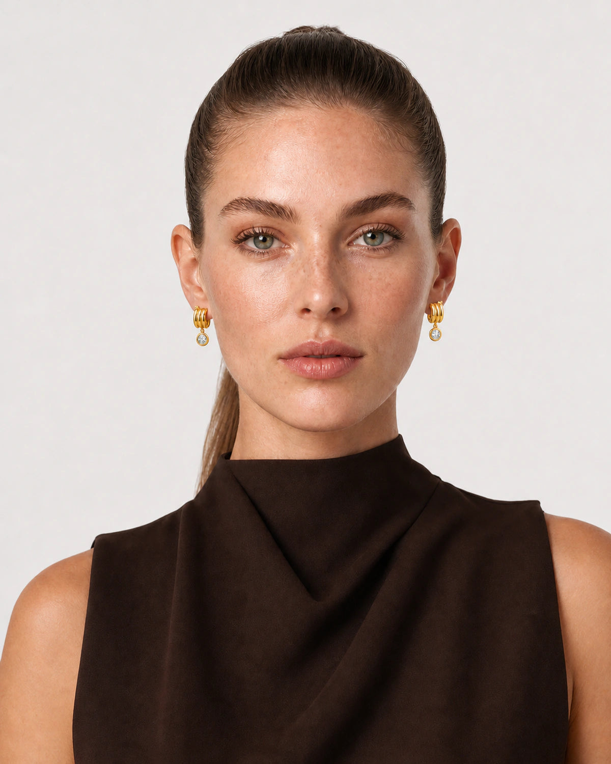 Model in espresso tailoring wearing Astra zircon drop earrings