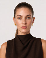 Model in espresso tailoring wearing Astra zircon drop earrings