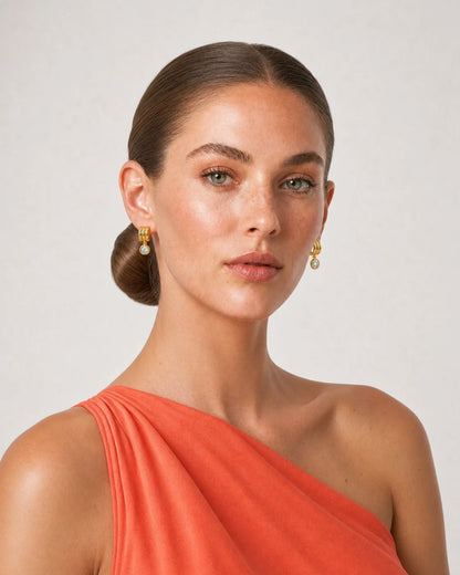 Three-quarter studio portrait of Freya wearing the Astra zircon drop earrings
