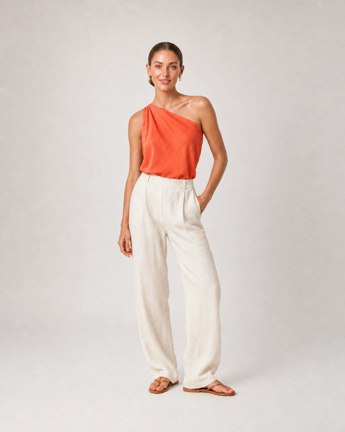 Full-body coral silk and ivory linen portrait featuring the Astra earrings