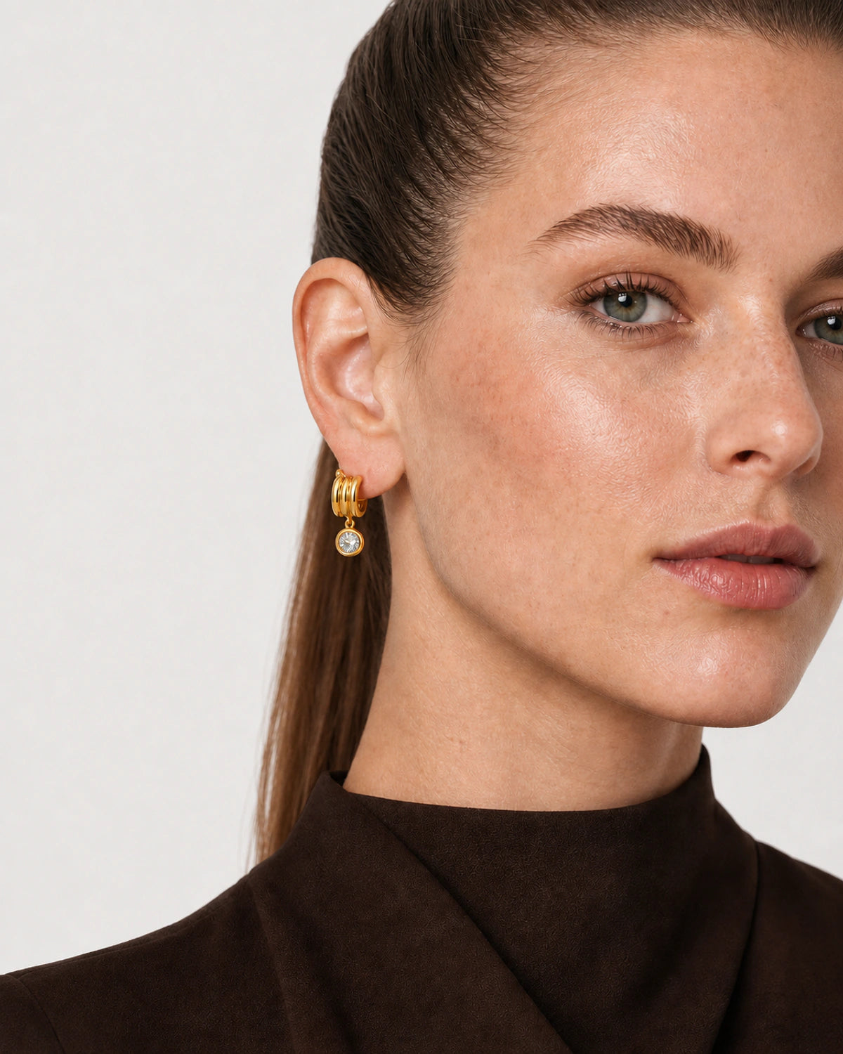 Clean ear close-up of an Astra triple arc zircon earring