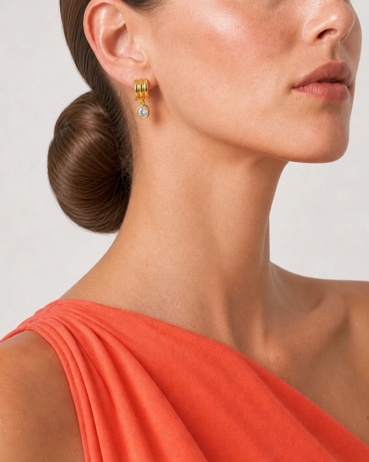 Eye-free side ear and jaw close-up of Freya wearing an Astra triple-arc earring
