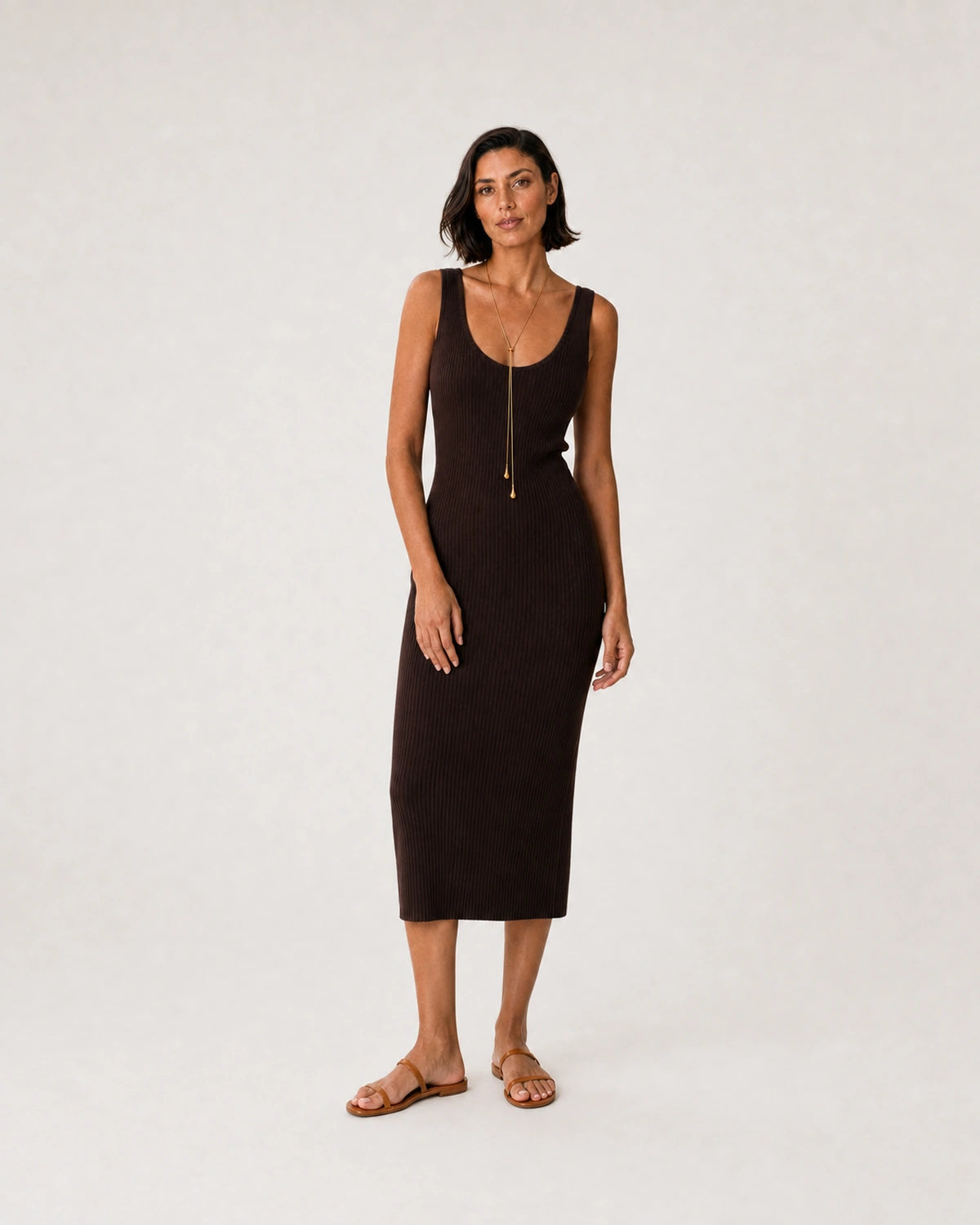 Full-body espresso knit summer portrait featuring the Aurelia droplet lariat