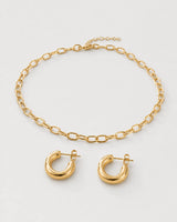 Aurelle gold oval-link necklace and sculpted hoop set on seamless pale dove-grey
