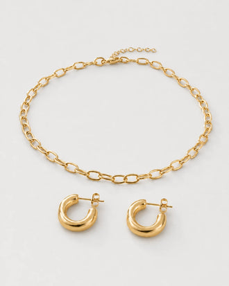 Aurelle gold oval-link necklace and sculpted hoop set on seamless pale dove-grey