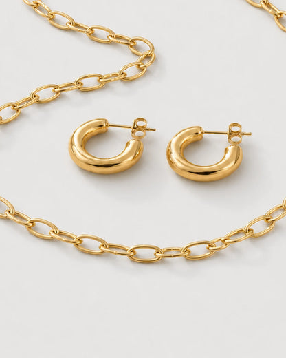 Macro detail of the Aurelle necklace links, sculpted hoops, posts and backs