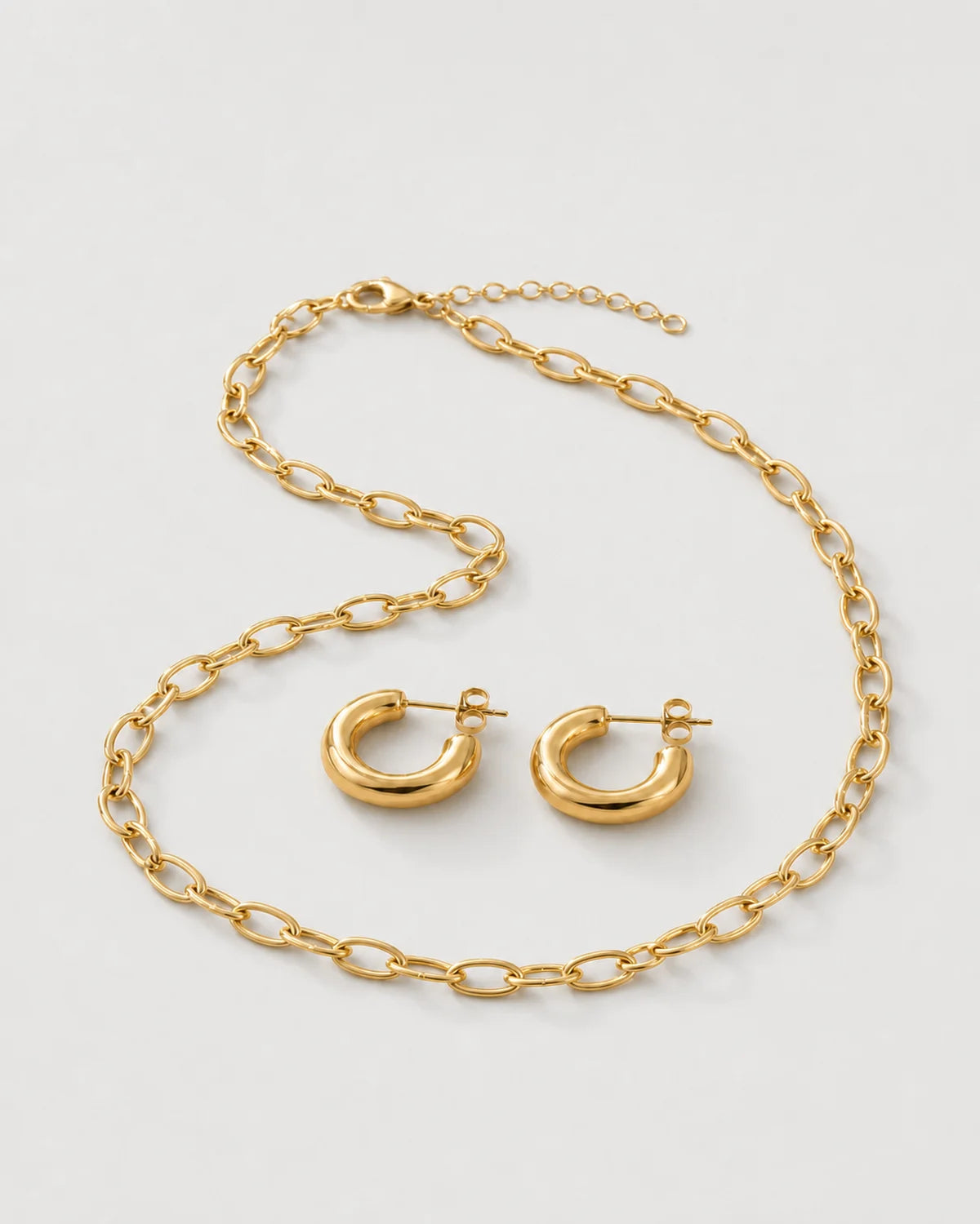 Alternate arrangement of the Aurelle everyday jewellery set on pale dove-grey