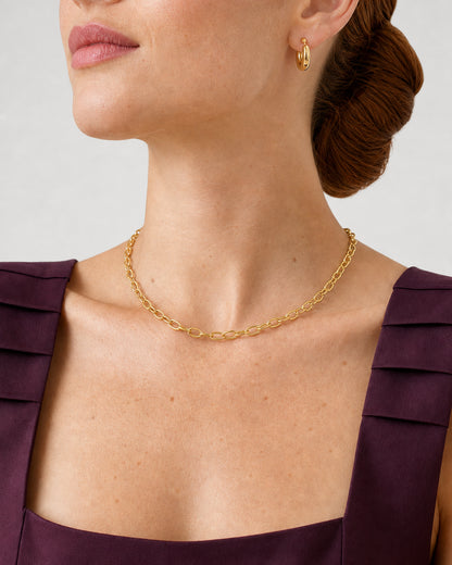 Three-quarter wearing view of the Aurelle gold necklace and compact open hoop
