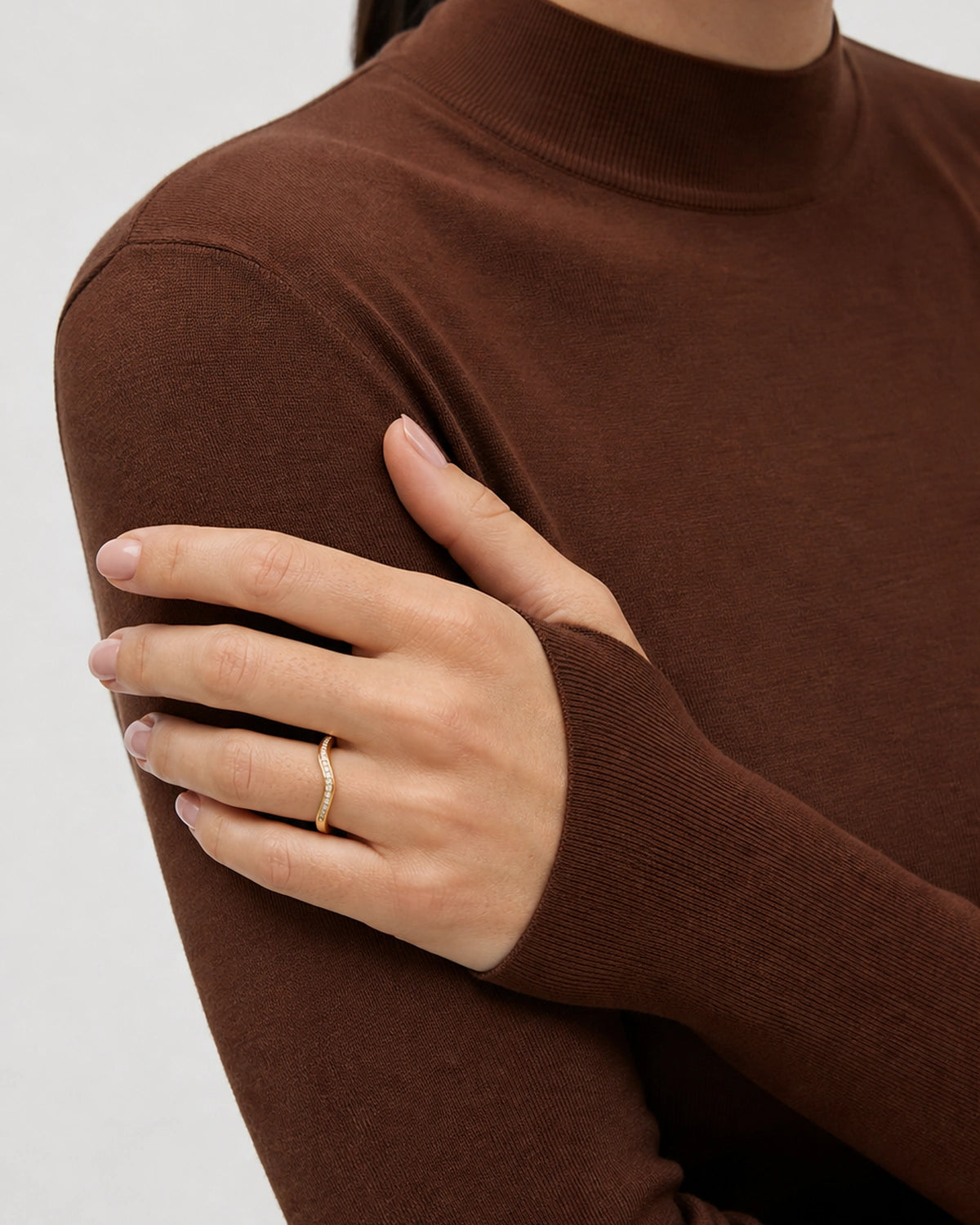 Aurelle gold pavé band worn with the hand across the opposite upper arm