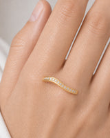 Extreme on-hand macro of the Aurelle gold wave and single pavé channel