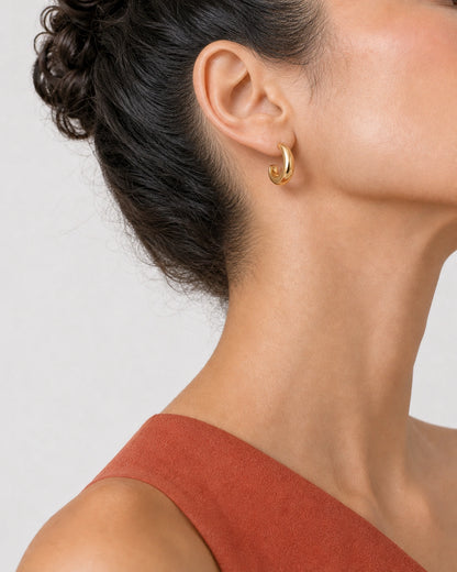 Alternate lower-face wearing view of the Aurelle gold sculpted hoop