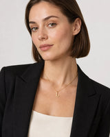 British model aged 26 in black tailoring wearing the Aveline gold L necklace