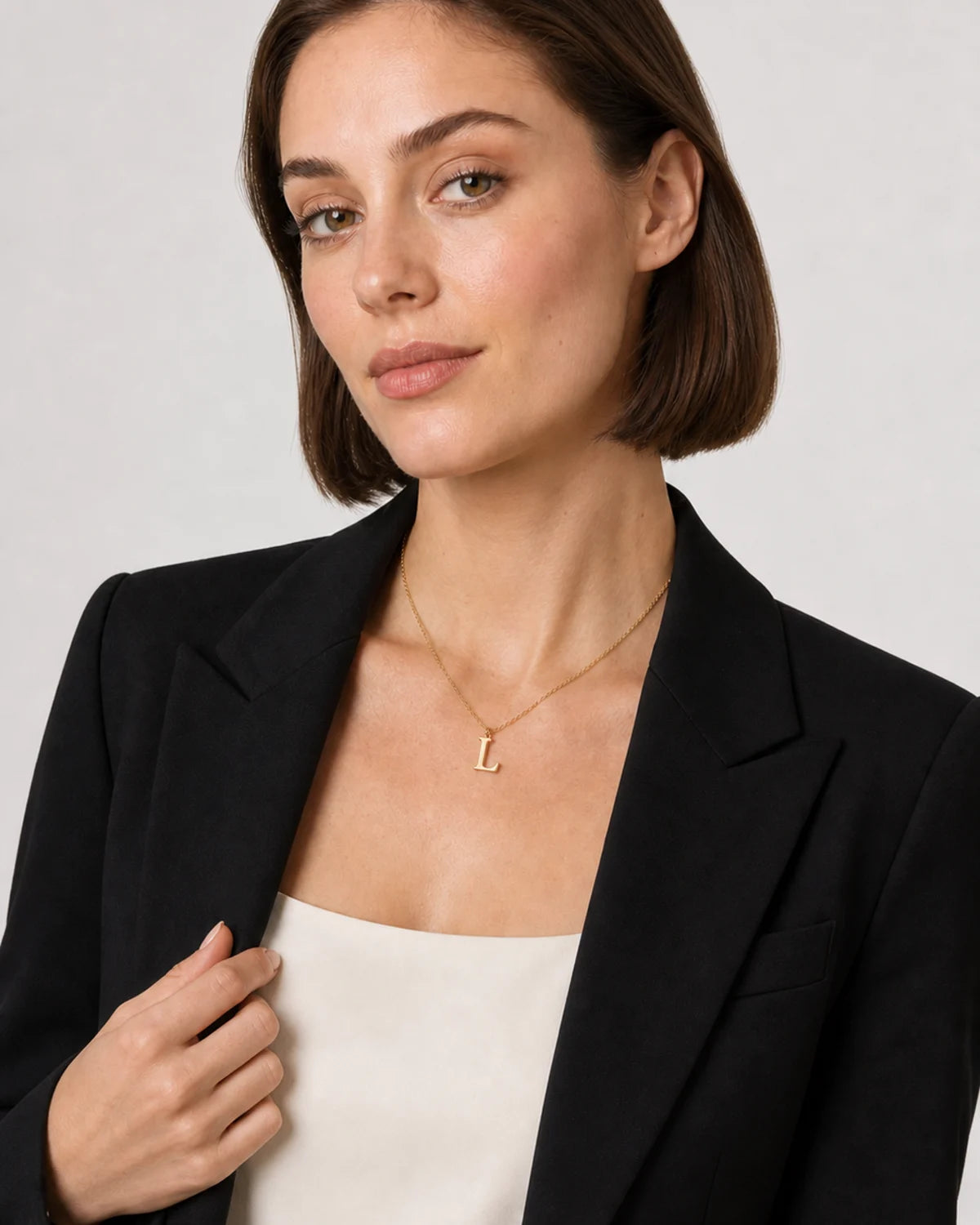 Alternate studio portrait of the same model wearing the Aveline initial necklace
