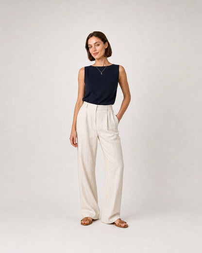 Full-body navy knit and cream linen portrait featuring the Aveline L necklace