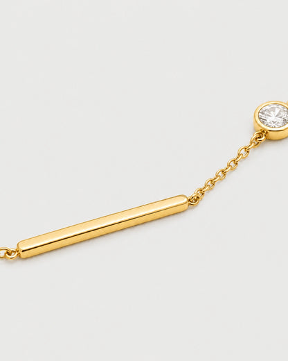 Macro of Aven polished gold bar and offset bezel zircon bracelet