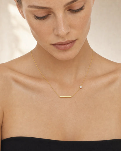 Clean collarbone close-up of the Aven bar and zircon station necklace