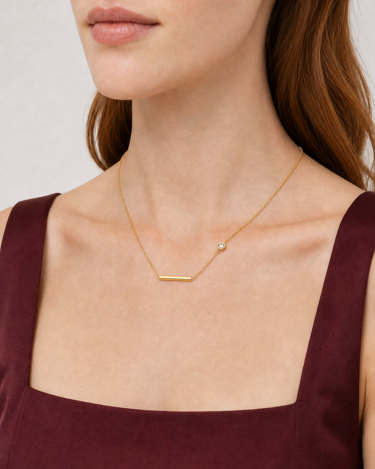 Eye-free three-quarter neckline view of Harriet wearing the Aven necklace