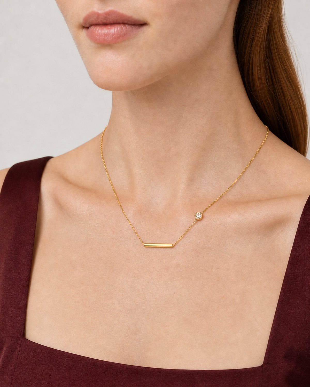 Eye-free alternate neckline detail of Harriet wearing the Aven bar and zircon necklace