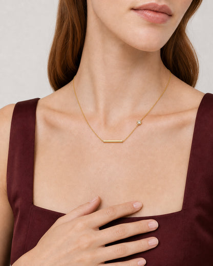 Eye-free hand and collarbone detail of Harriet wearing the Aven station necklace