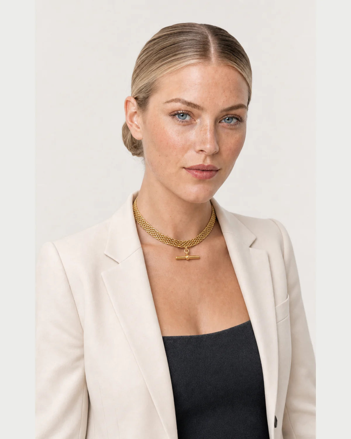 Three-quarter studio portrait featuring the Camille gold collar