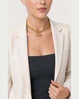Model holding her blazer lapel while wearing the Camille collar
