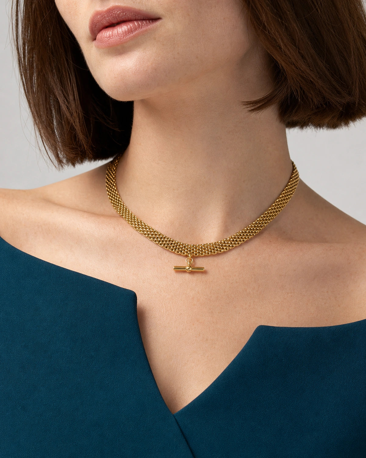 Front mouth-down wearing view of the Camille five-row T-bar collar with ink-teal tailoring