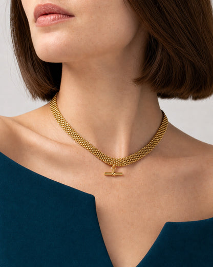 Jewellery-led worn detail of Camille's five link rows and horizontal T-bar