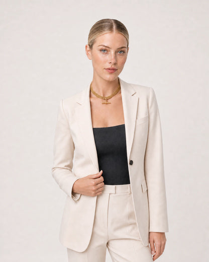 Wide grey-studio editorial portrait featuring the Camille T-bar collar