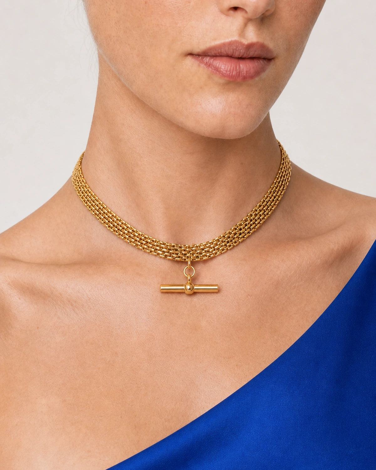Close wearing view of Camille's five gold rows and centred T-bar
