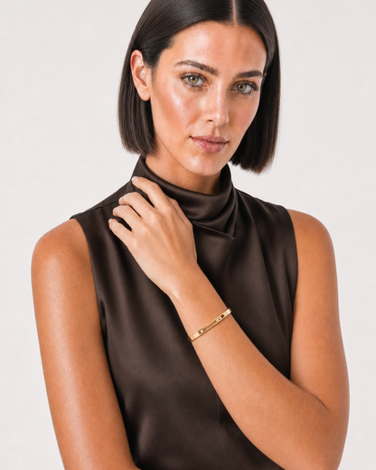 Australian model aged 25 to 28 wearing the Celene floating crystal bangle in a pale dove-grey studio