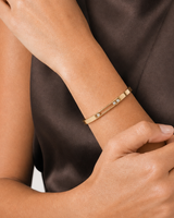 Human-scale close view of the Celene floating crystal bangle across the model's wrist