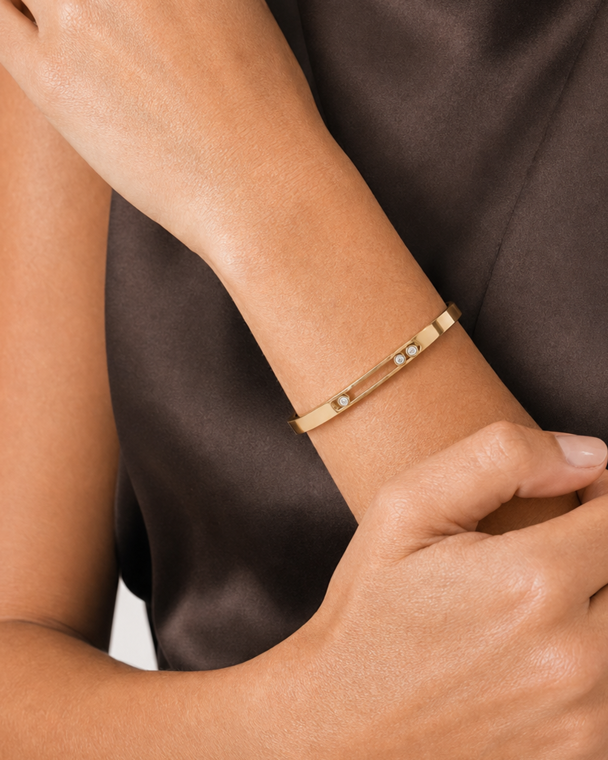Human-scale close view of the Celene floating crystal bangle across the model's wrist