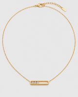 Celene gold floating crystal bar necklace on a seamless pale dove-grey studio background