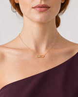 Frontal mouth-down view of Georgia wearing the Celene gold crystal-bar necklace