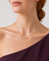 Three-quarter mouth-down view of Georgia wearing the Celene crystal-bar necklace