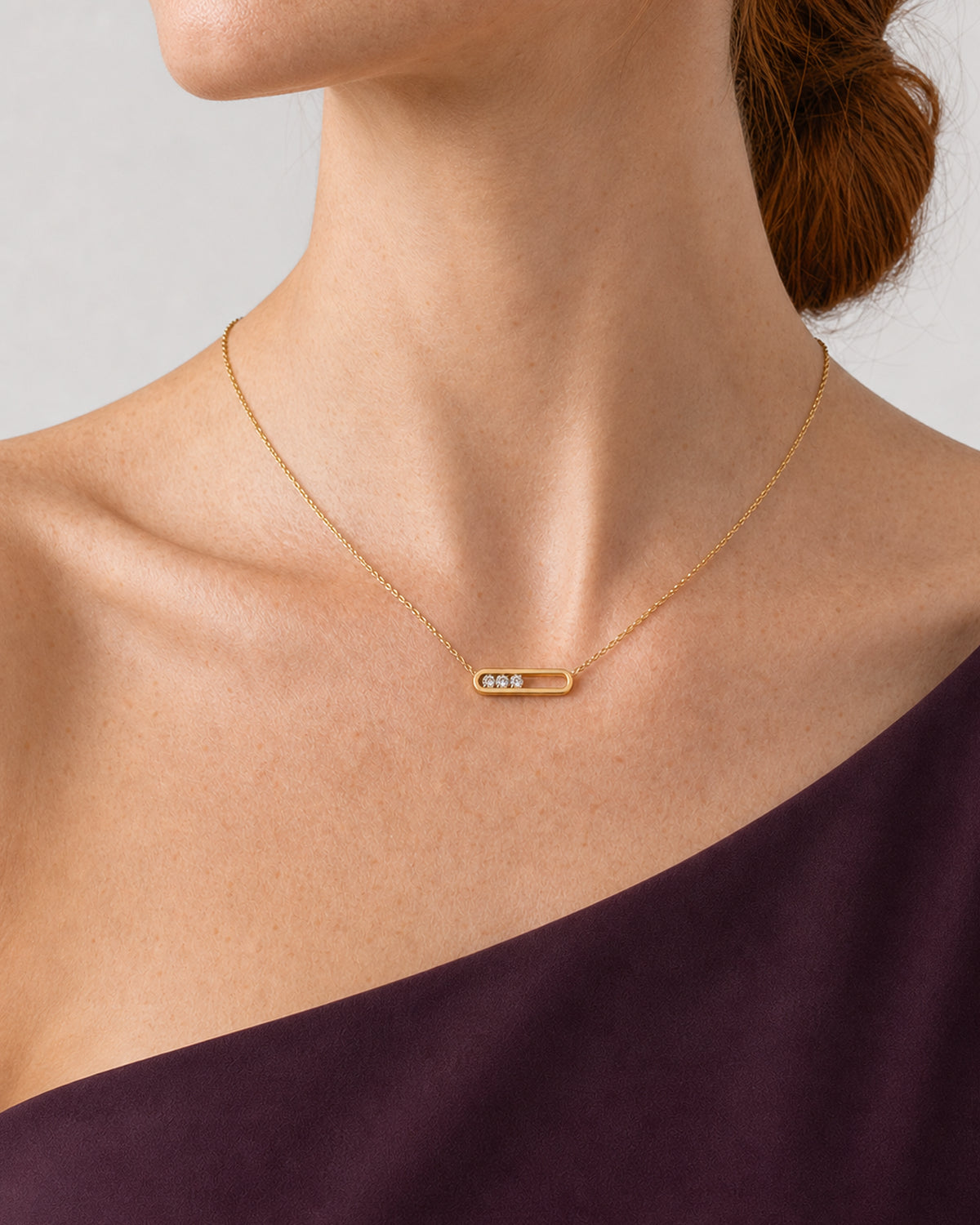 Tight side-neckline detail of the Celene gold floating-crystal bar necklace