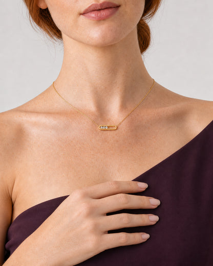 Frontal worn detail of the Celene crystal-bar necklace with a relaxed hand below