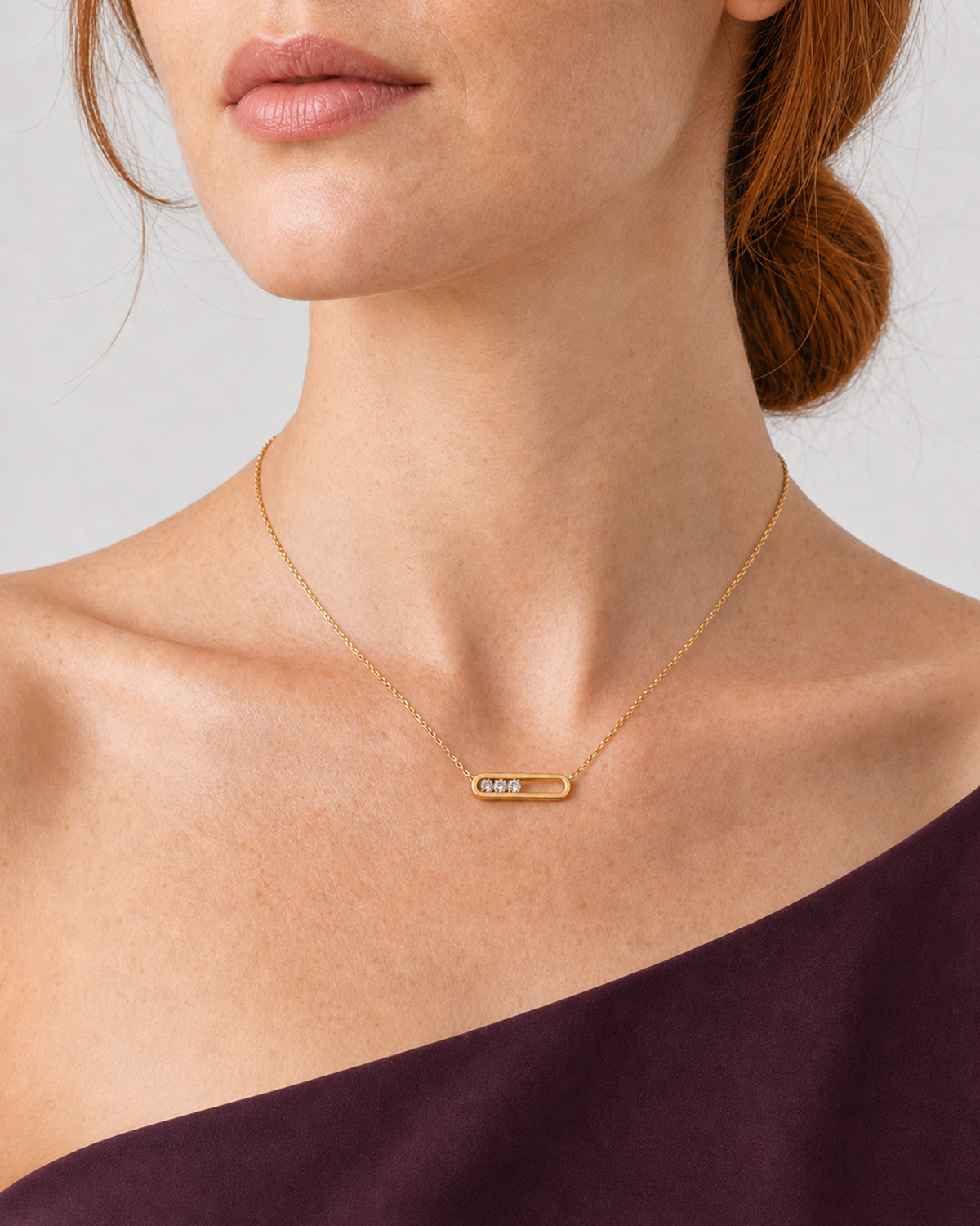 True worn macro of the complete Celene floating-crystal bar pendant at natural scale