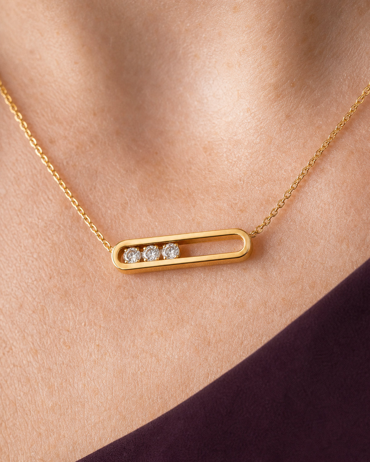 Extreme worn macro of the Celene open gold bar, three crystals and chain connections