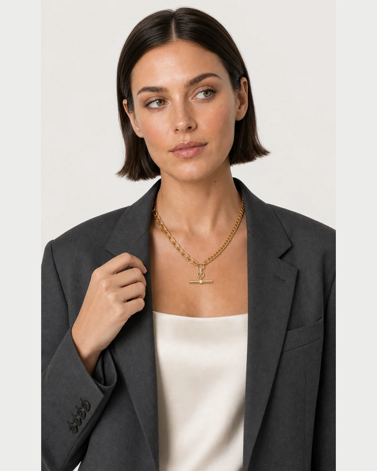 Human-scale styling portrait of the Célestine necklace with charcoal tailoring