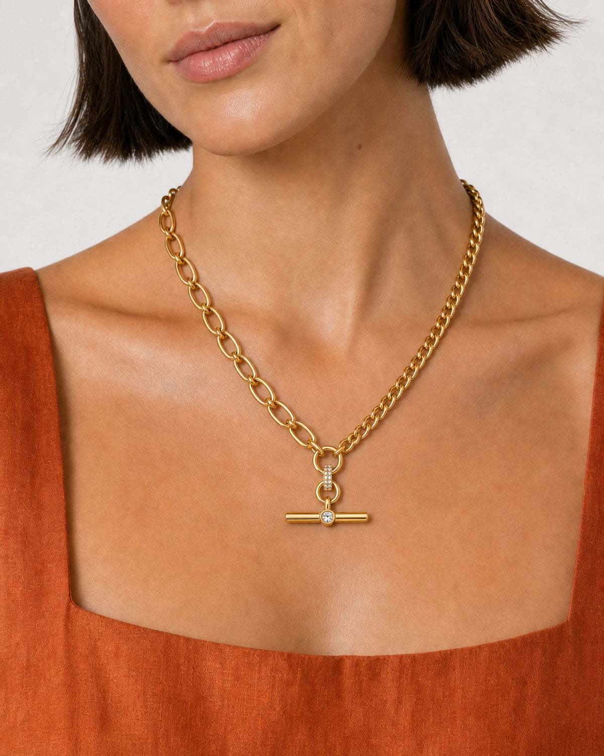Close-up of the Célestine mixed-link necklace with terracotta summer styling