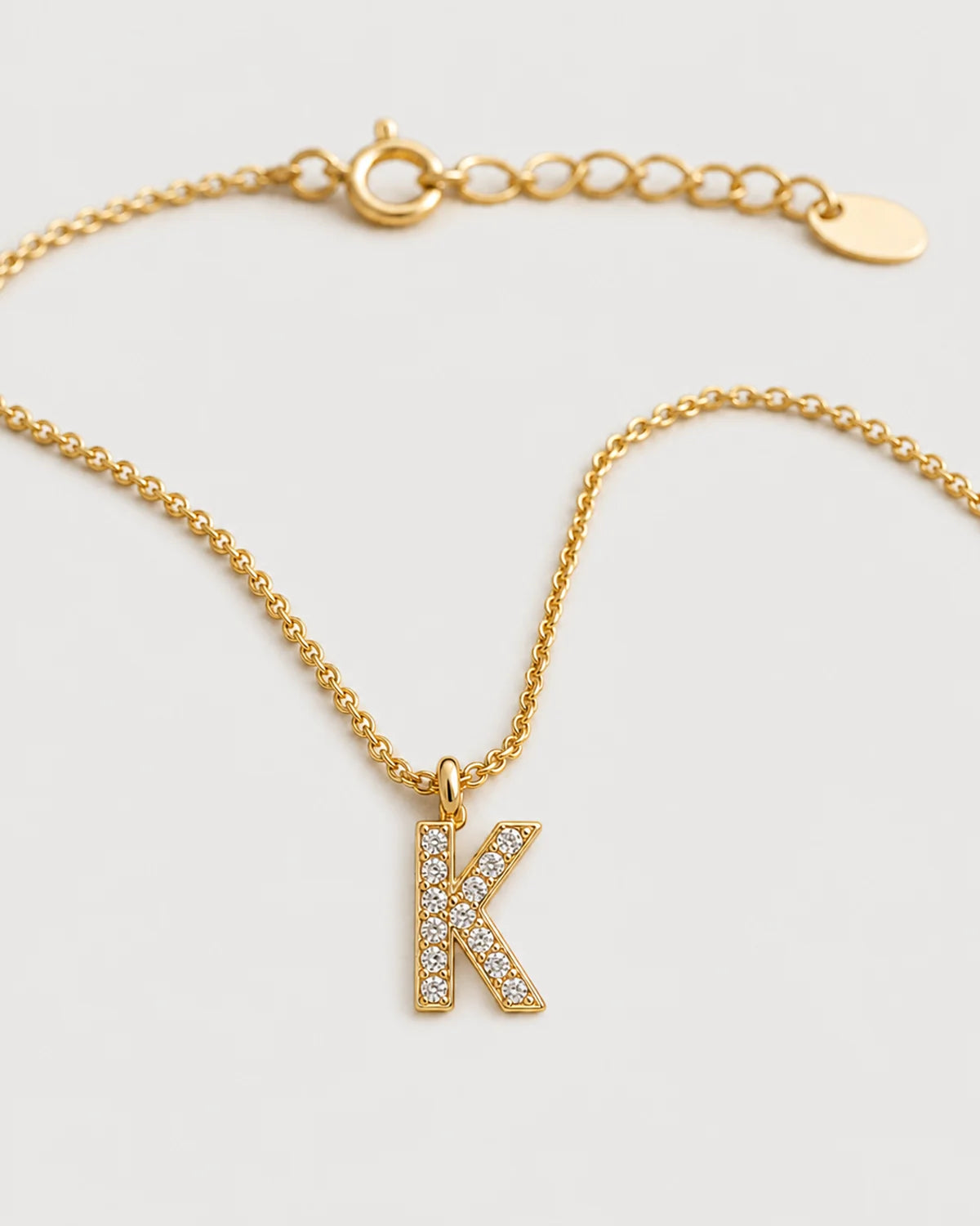 Macro detail of the Ciel upright pavé K pendant, spring-ring clasp and extender