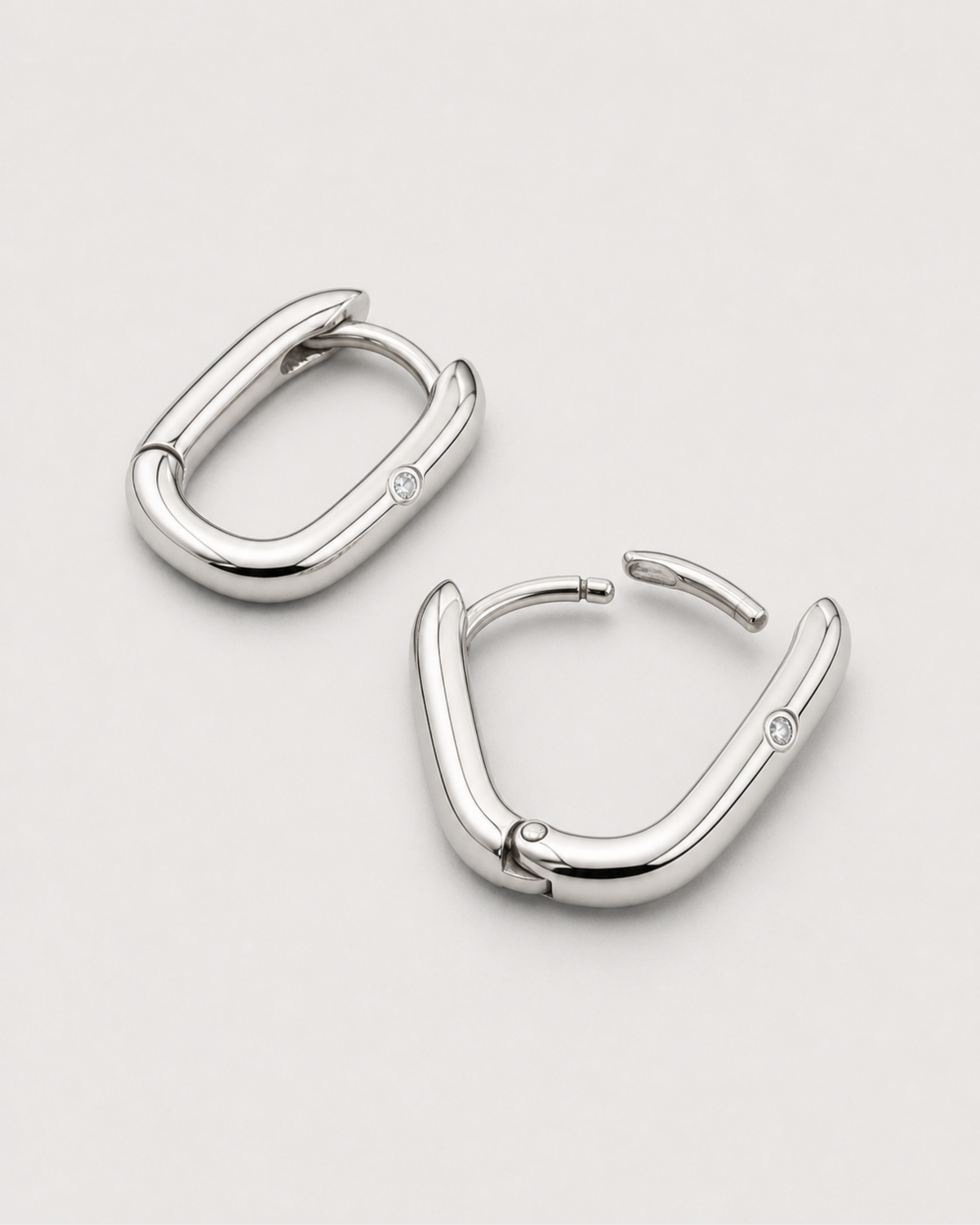 Closed and open construction view of the Clea silver hinged huggies