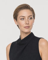 Alternate portrait of the same model wearing the Clea silver huggies