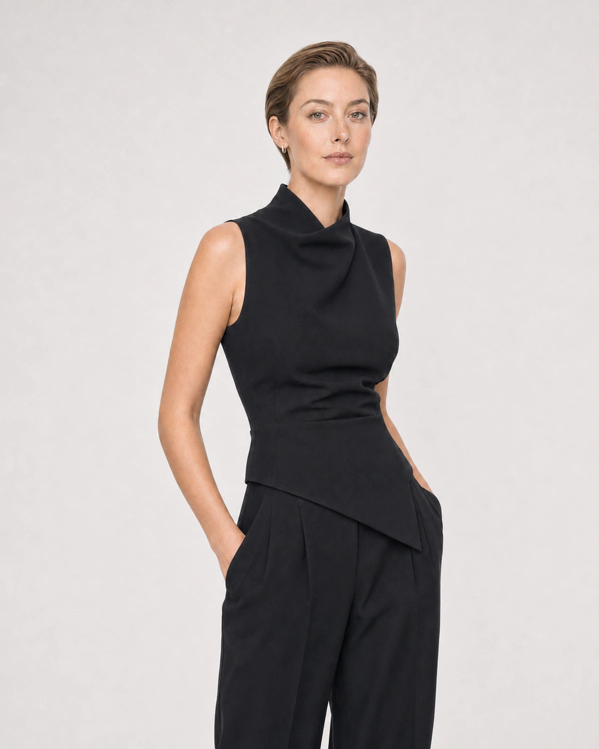 Human-scale studio view of the Clea huggies with sleeveless black styling